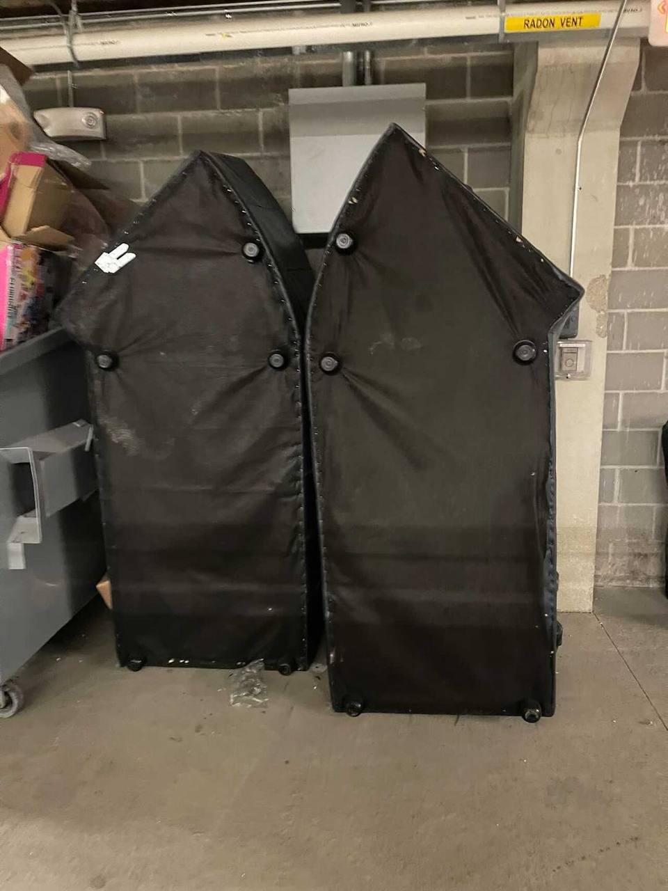 Two large padded booth sections staged for removal